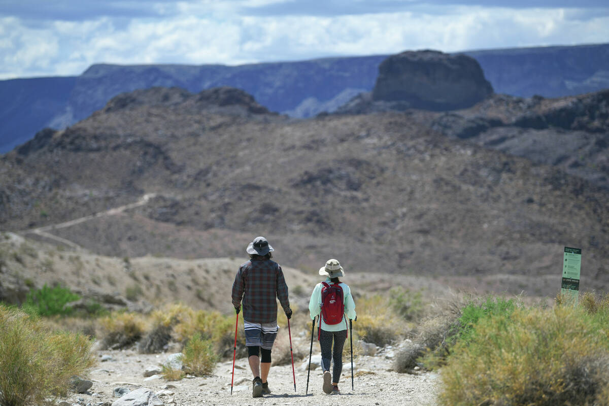 Hikers head out on the Arizona Hot Springs trail south of the Hoover Dam before the trails are ...