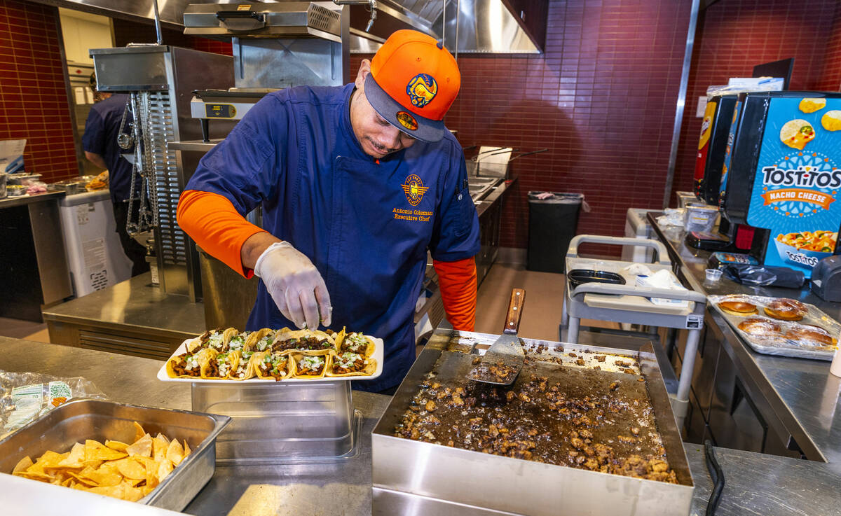 Executive Chef Antonio Coleman prepares a plate of al pastor, chicken and carne asada tacos as ...