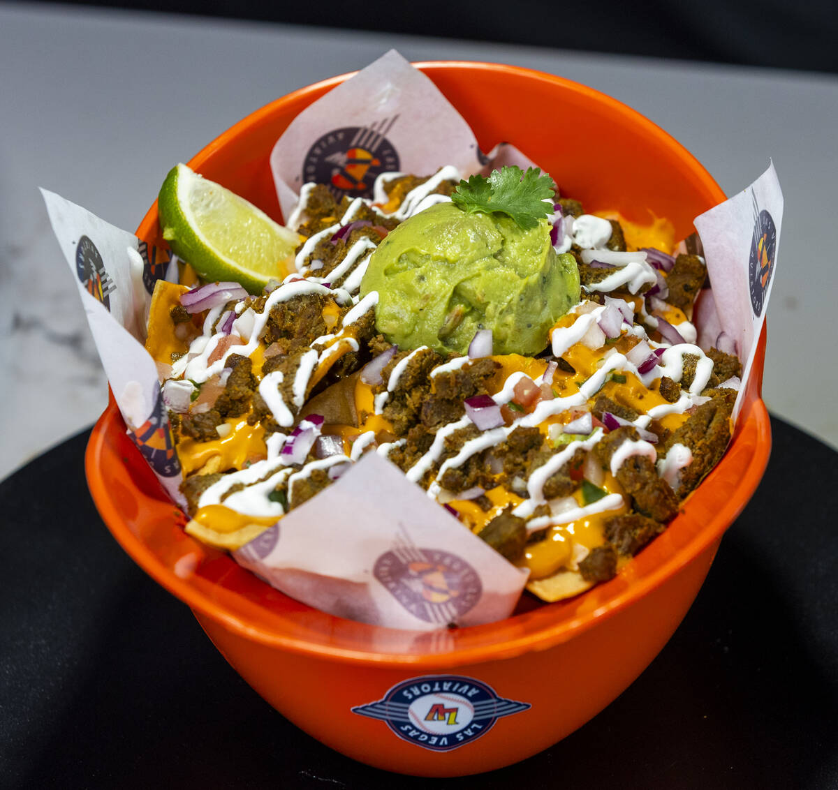 A souvenir carne asada nachos helmet Is one of the new items available from the concessions at ...