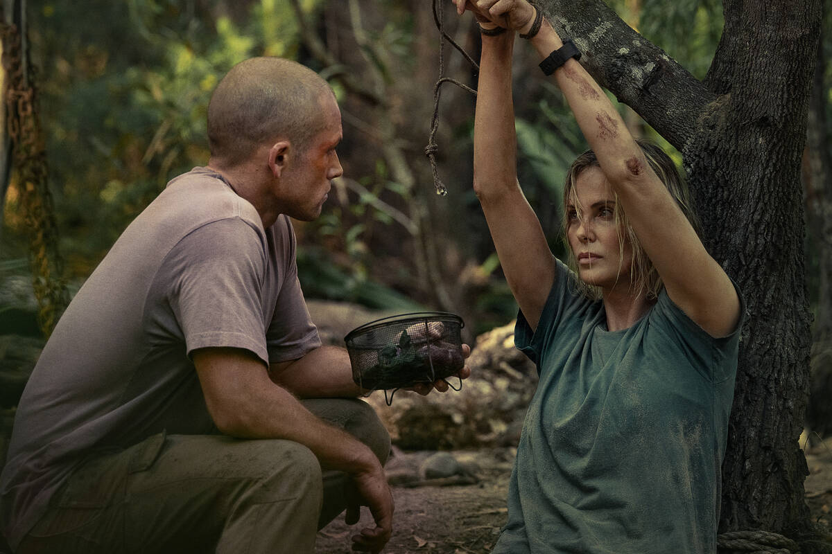 APEX. (L-R) Taron Egerton as Ben and Charlize Theron as Sasha in APEX. Cr. Kane Skennar/Netflix ...