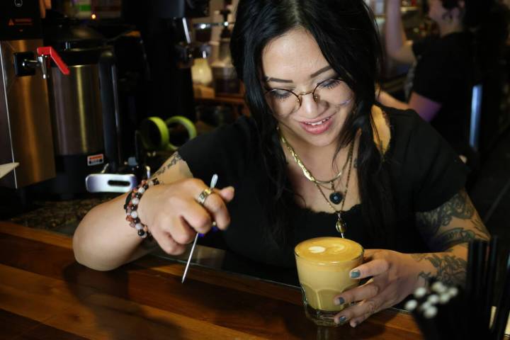 Lead barista Mae Delrosario makes a latte at the cafe at The Griffin on Fremont East on Tuesday ...