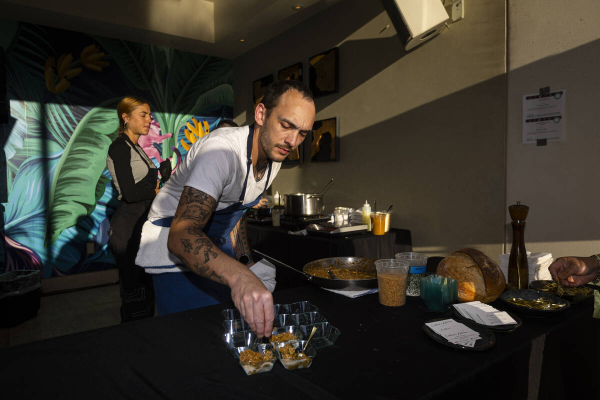 Chef Dylan Jobsz of Esther's Kitchen prepares Jaffna crab curry with rotini crispy garlic ...