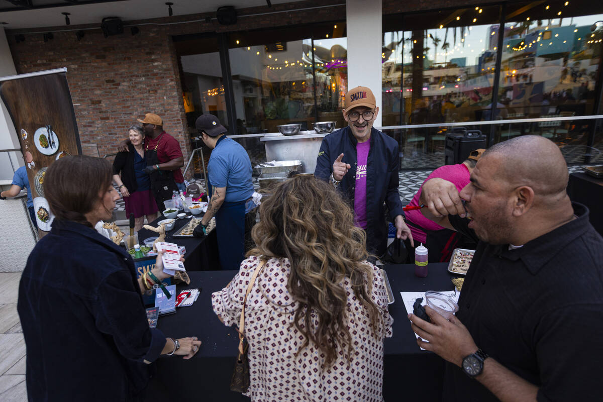 Chef Alex Reznik of Hayworth & SMKD, center right, talks with attendees during Vegas Unstri ...