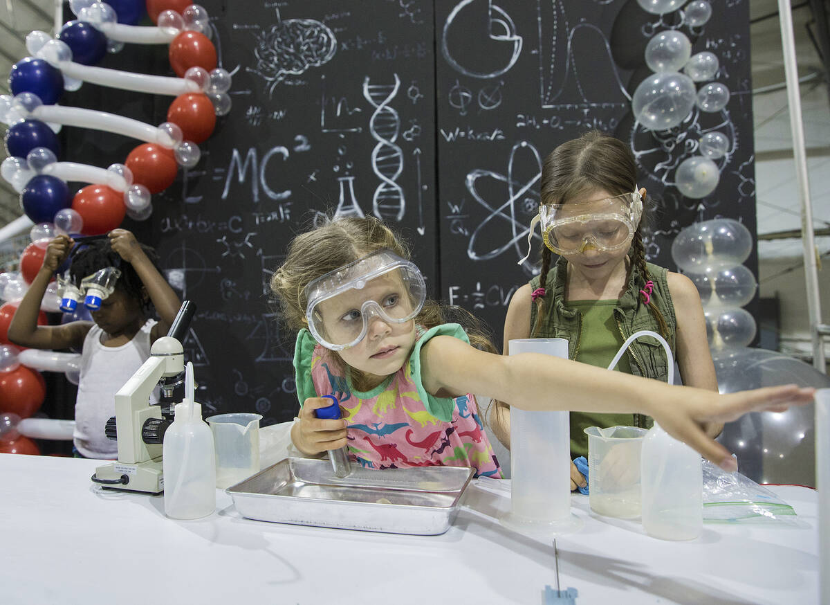 Sisters Isabella, left, 5, and Emma Anderson, 9, explore a kids laboratory during the Las Vegas ...