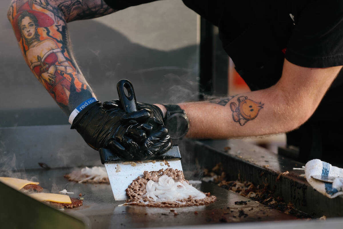 A smashed onion burger from With Love, Always is prepared for waiting guests during the Taste o ...