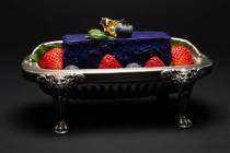 "The Cake of the Fates," an ube-infused cheesecake, fresh seasonal berries, raspberry coulis at ...