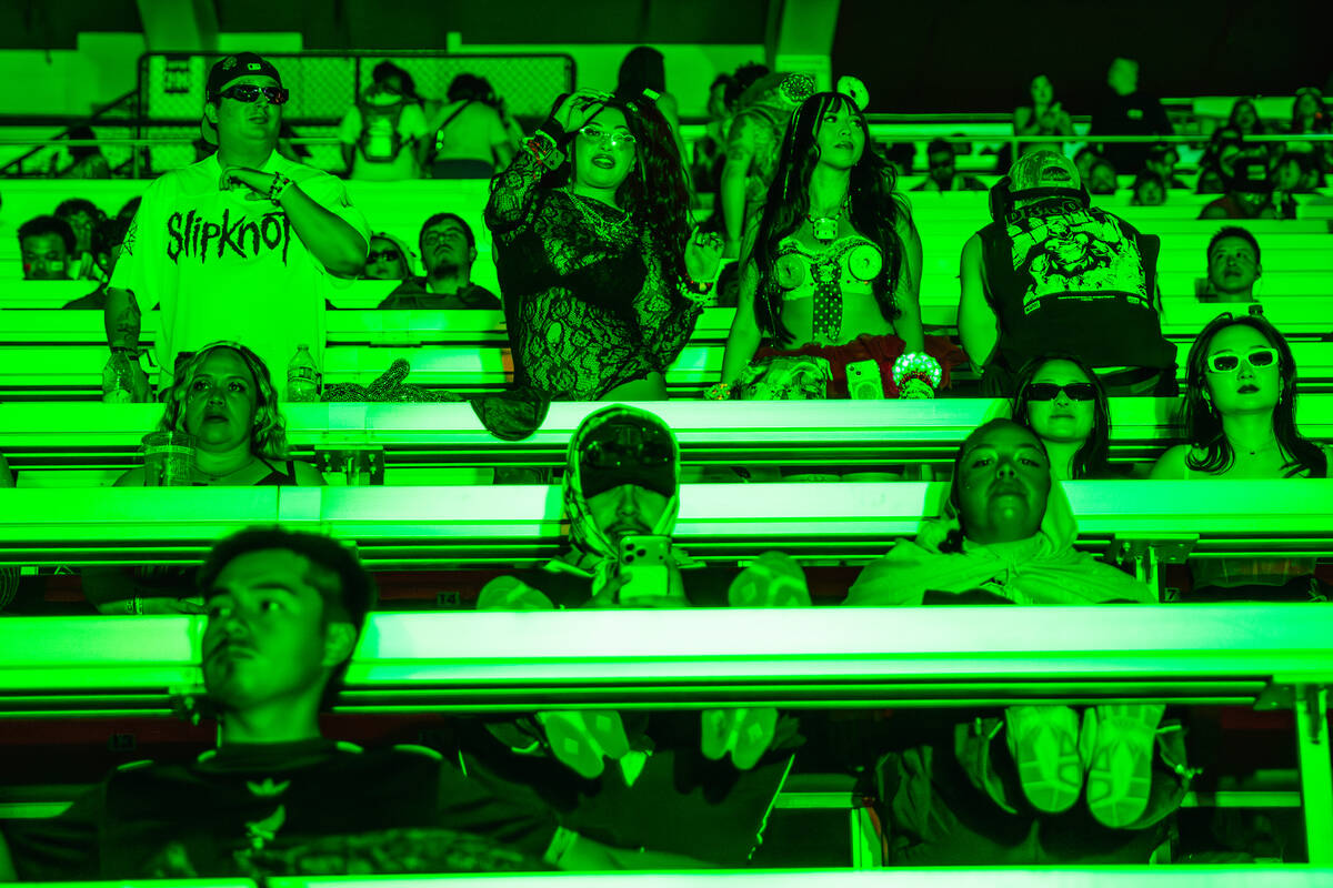 Attendees rest in the bleachers during day two of Electric Daisy Carnival at the Vegas Motor Sp ...