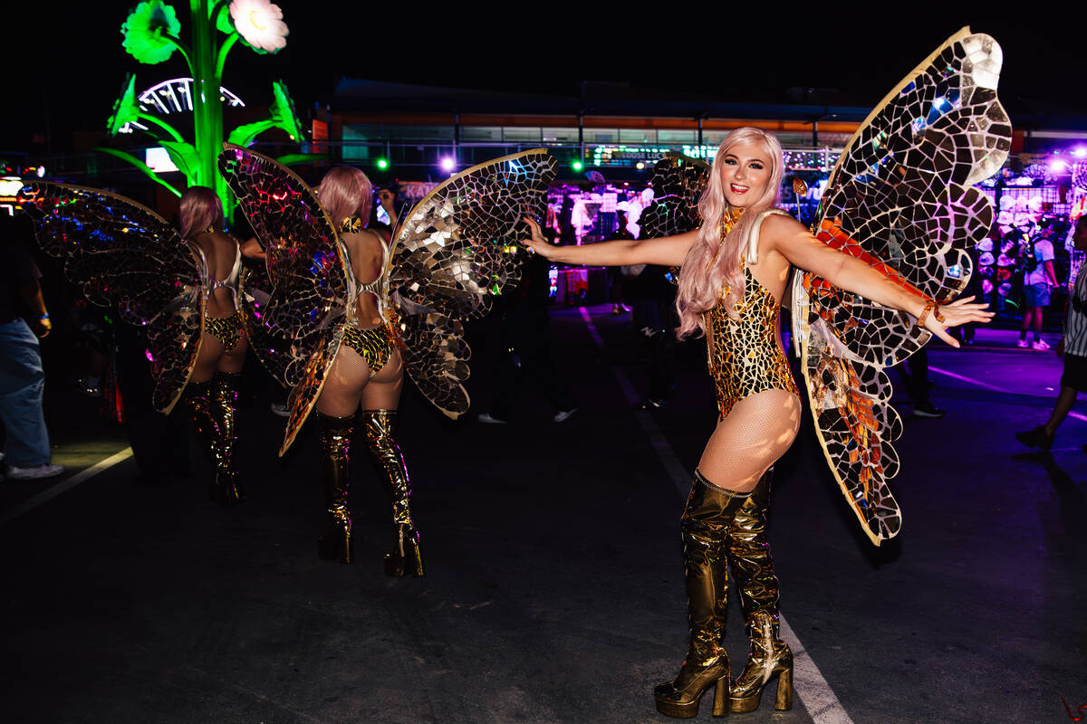 Performers walk throughout the Speedway during day two of the Electric Daisy Carnival at the La ...