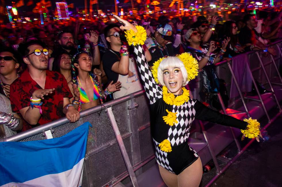 A performer dances with attendees during the final night of the Electric Daisy Carnival at Las ...