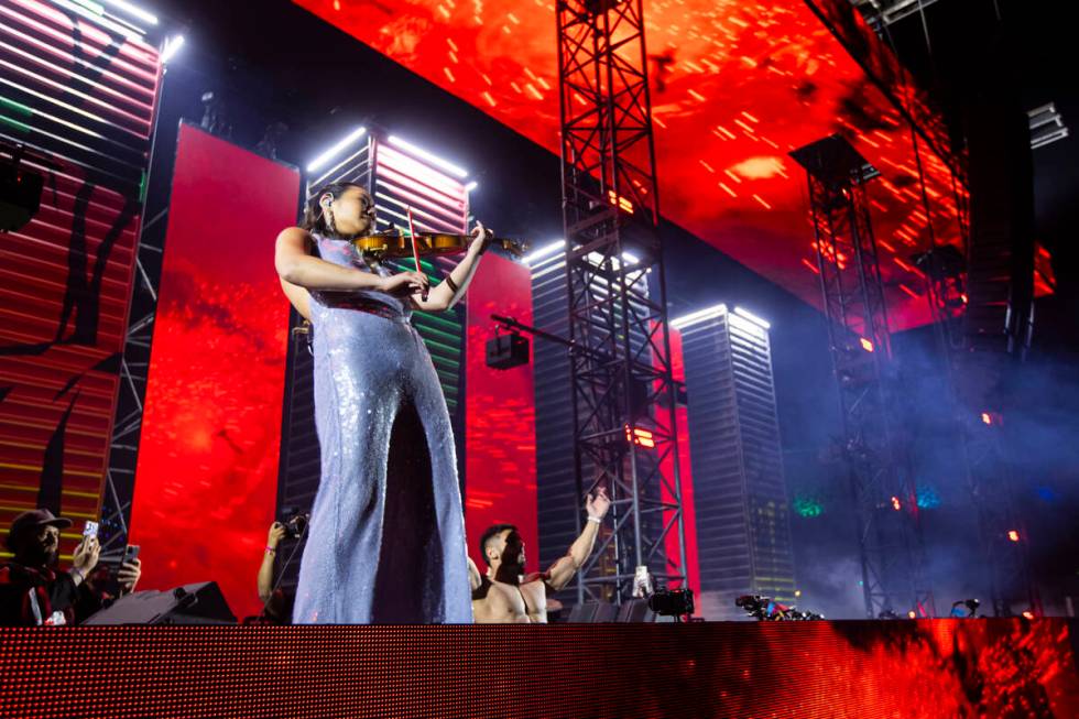 A violinist performs with Yosuf at the Wasteland stage during the final night of the Electric ...