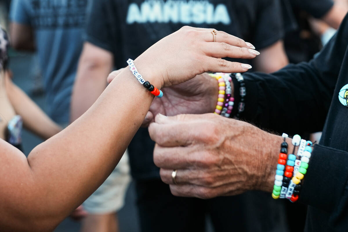 World Party Parade goers exchange bracelets during debut of an Electric Daisy Carnival parade d ...