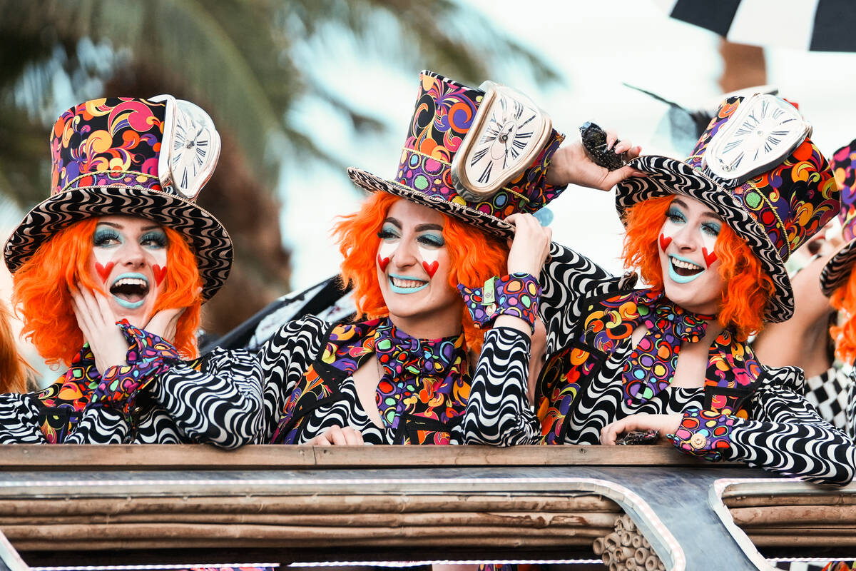World Party parade performers smile towards the audience during the debut of the Electric Daisy ...