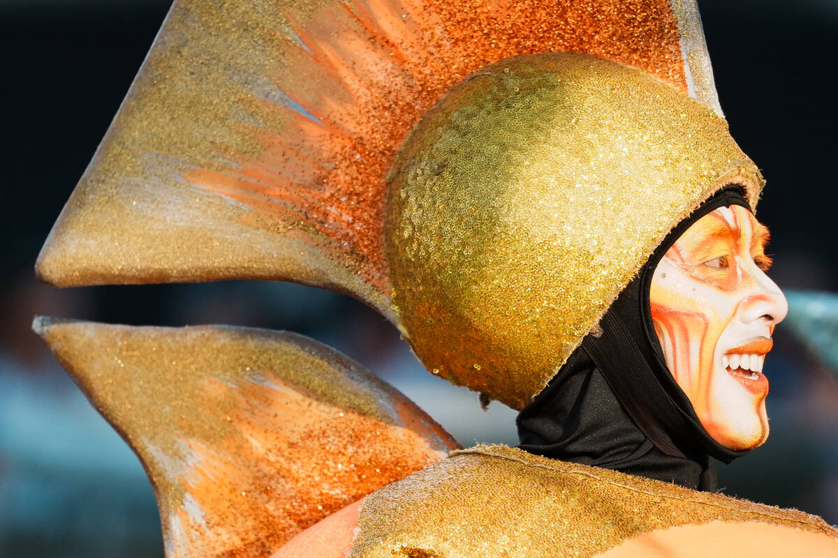 World Party parade performer sits atop a parade float during the debut of the Electric Daisy Ca ...