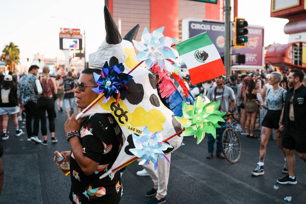 A World Party Parade goer carries a bull-shaped totem during debut of the Electric Daisy Carniv ...