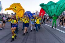 People dressed as Minions dance along the track during the first night of EDC at the Las Vegas ...