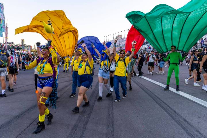 People dressed as Minions dance along the track during the first night of EDC at the Las Vegas ...