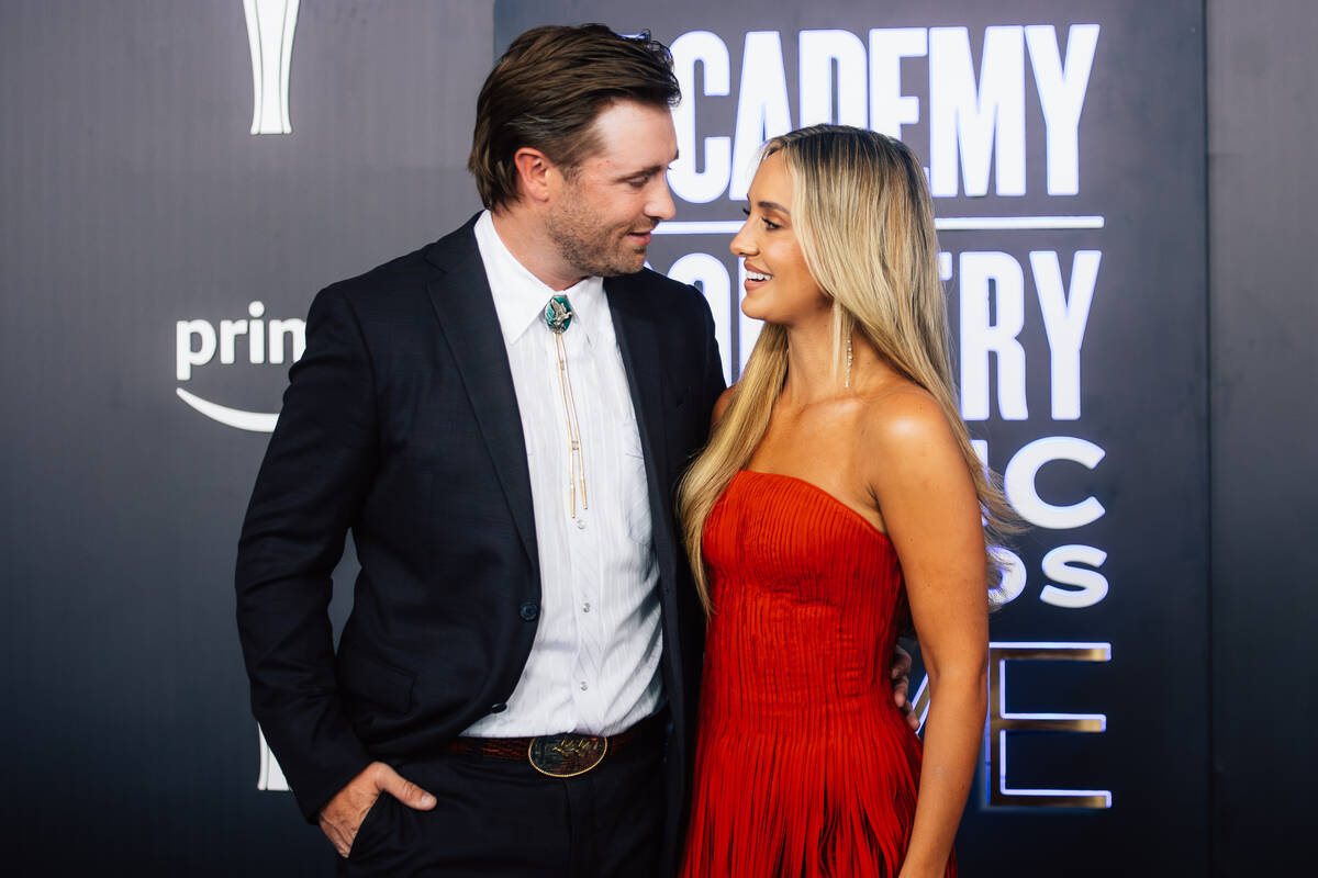 Lainey Wilson, right, and her husband, Devlin Hodges on the Academy of Country Music Awards red ...