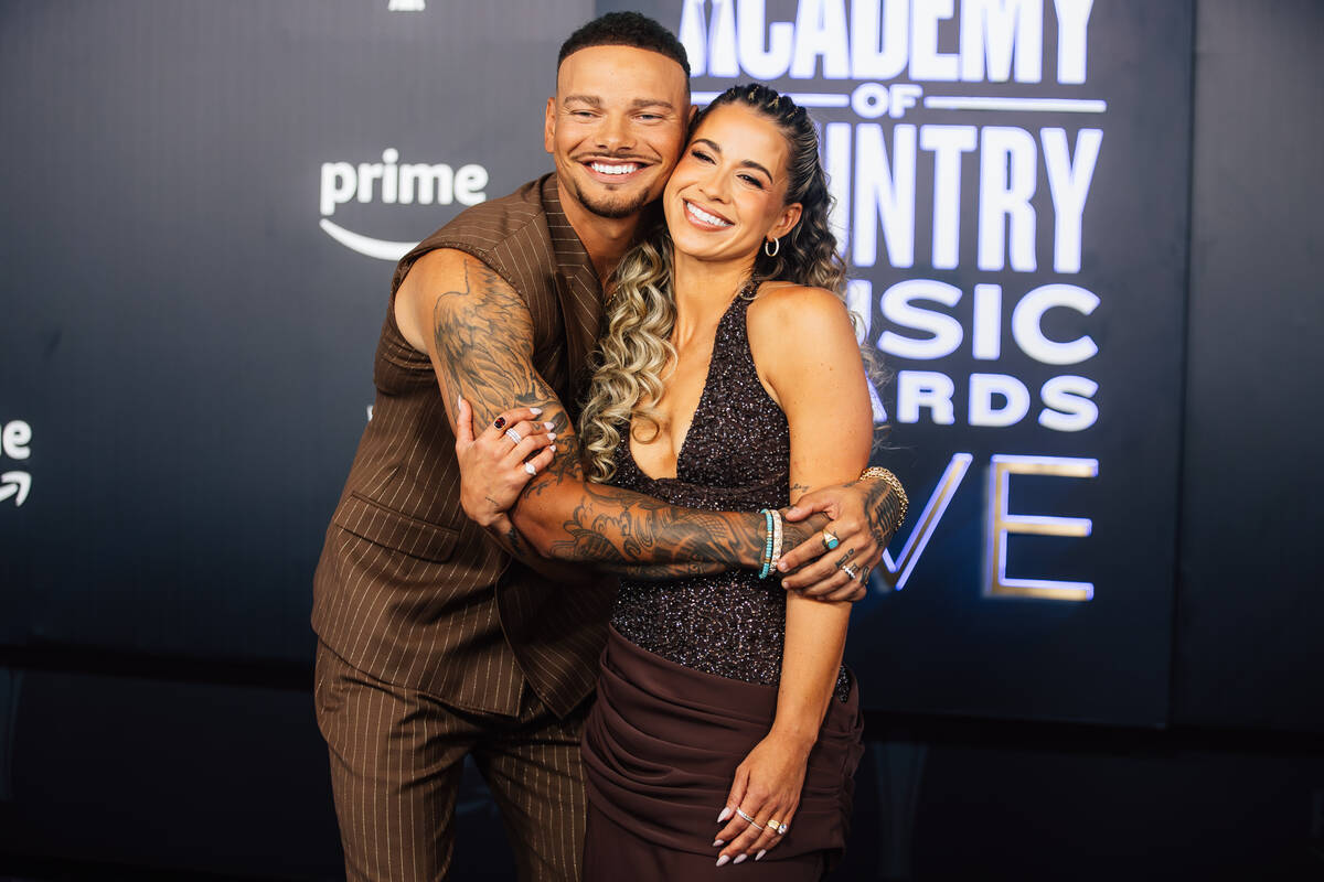 Kane Brown, left, hugs his wife, Katelyn Brown, on the Academy of Country Music Awards red carp ...
