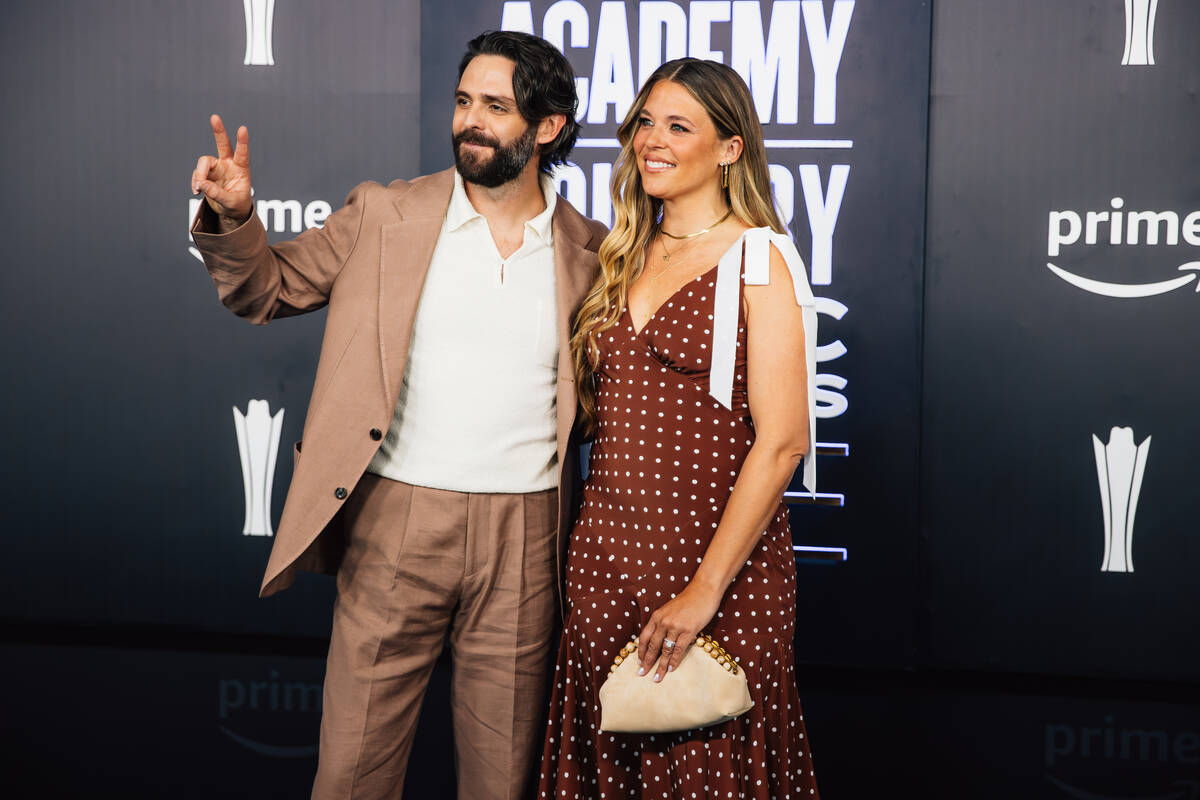 Thomas Rhett, left, and his wife, Lauren Atkins, on the Academy of Country Music Awards red car ...