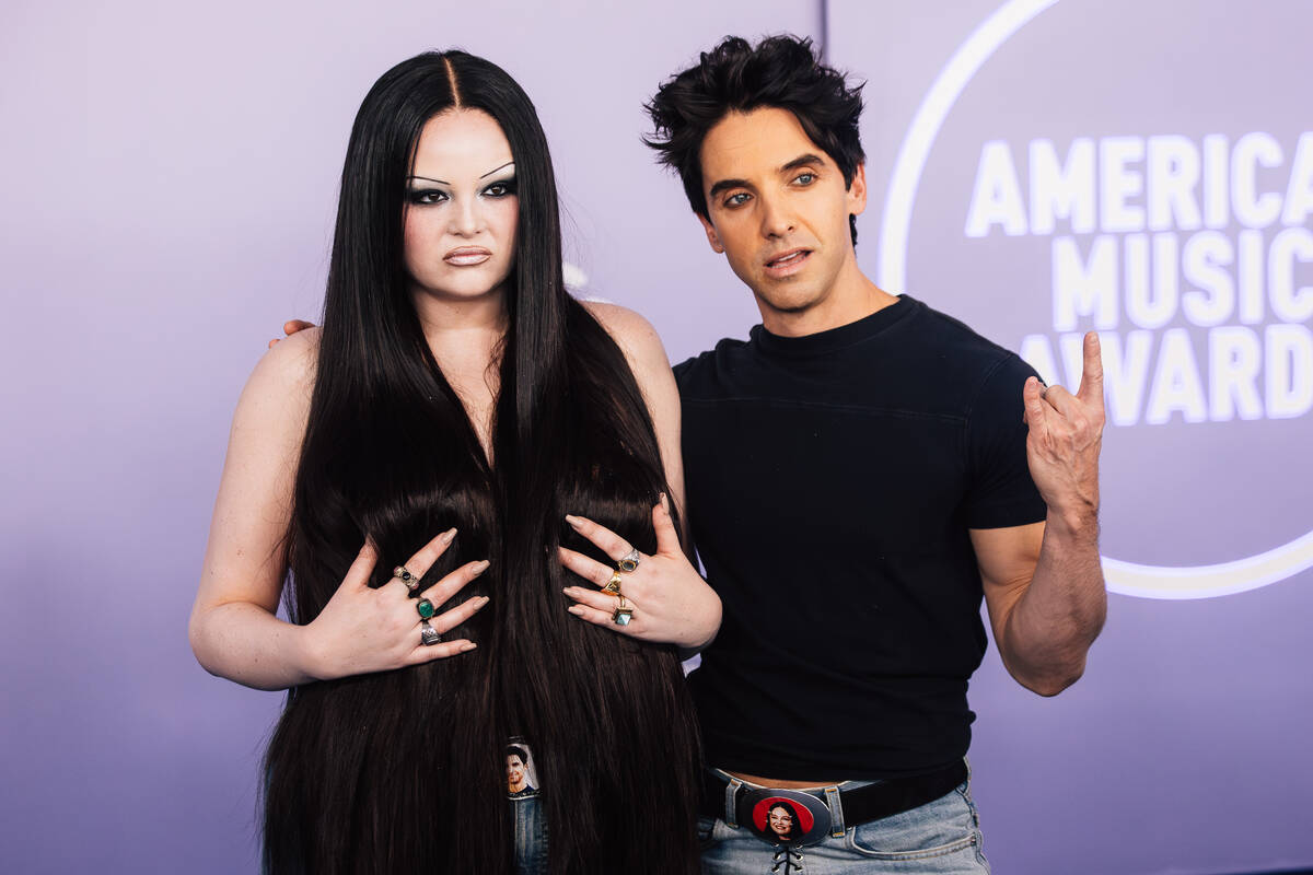 Meg Stalter and Paul W. Downs on the American Music Awards red carpet at MGM Grand Garden Arena ...