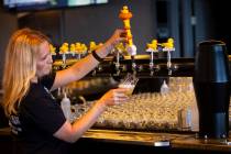 Ashley Wagner, general manager, pours the Atomic Duck IPA ahead of the opening of Able Baker Bo ...