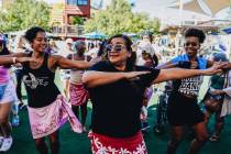 People participate in a Hawaiian-themed Zumba session at Downtown Container Park on Sunday, Aug ...