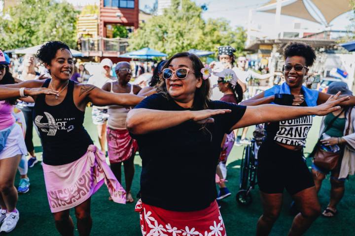 People participate in a Hawaiian-themed Zumba session at Downtown Container Park on Sunday, Aug ...