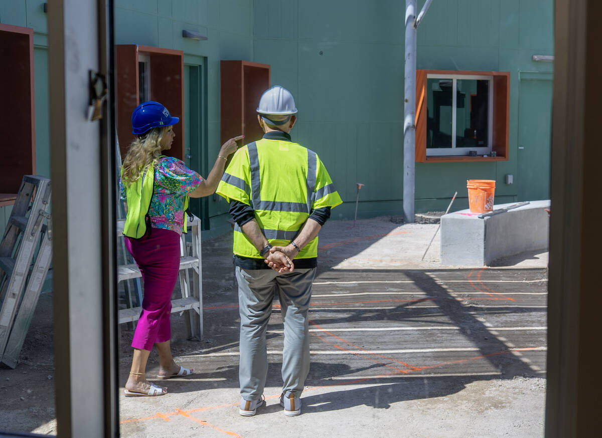 Boulder City Chamber CEO Jill Rowland-Lagan and Travel Nevada CEO Rafael Villanueva walk throug ...