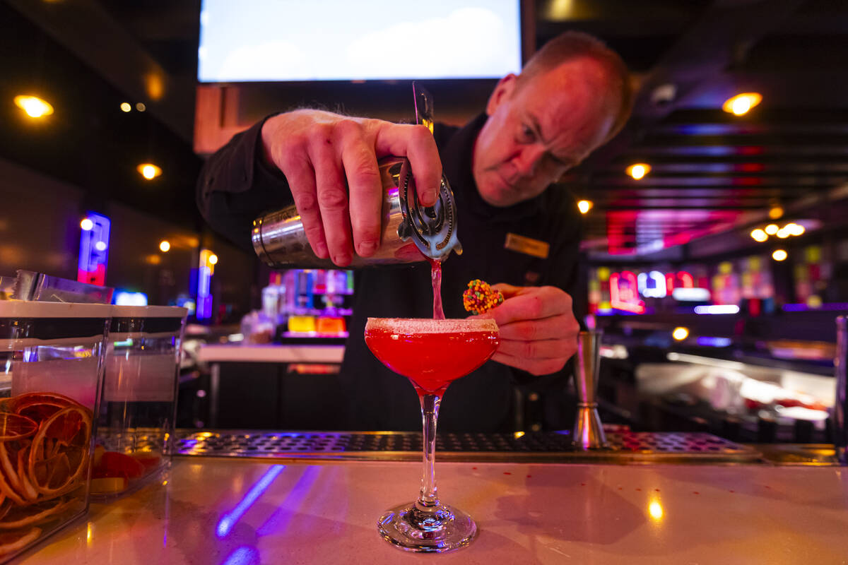 Bartender Bryan Seaton prepares the “crimson ghost rush” cocktail at the Bonus Ro ...