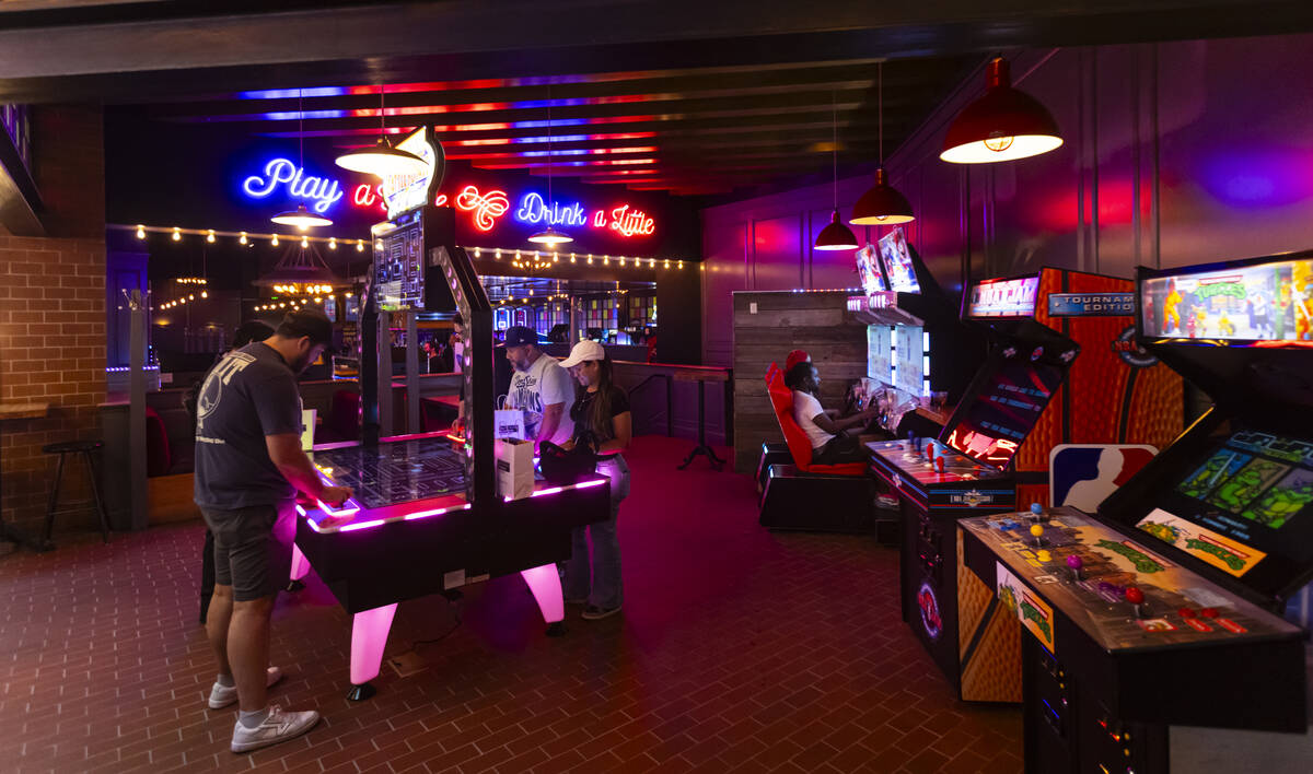 People play arcade games at the Bonus Round arcade bar at The District at MGM Grand on Thursday ...