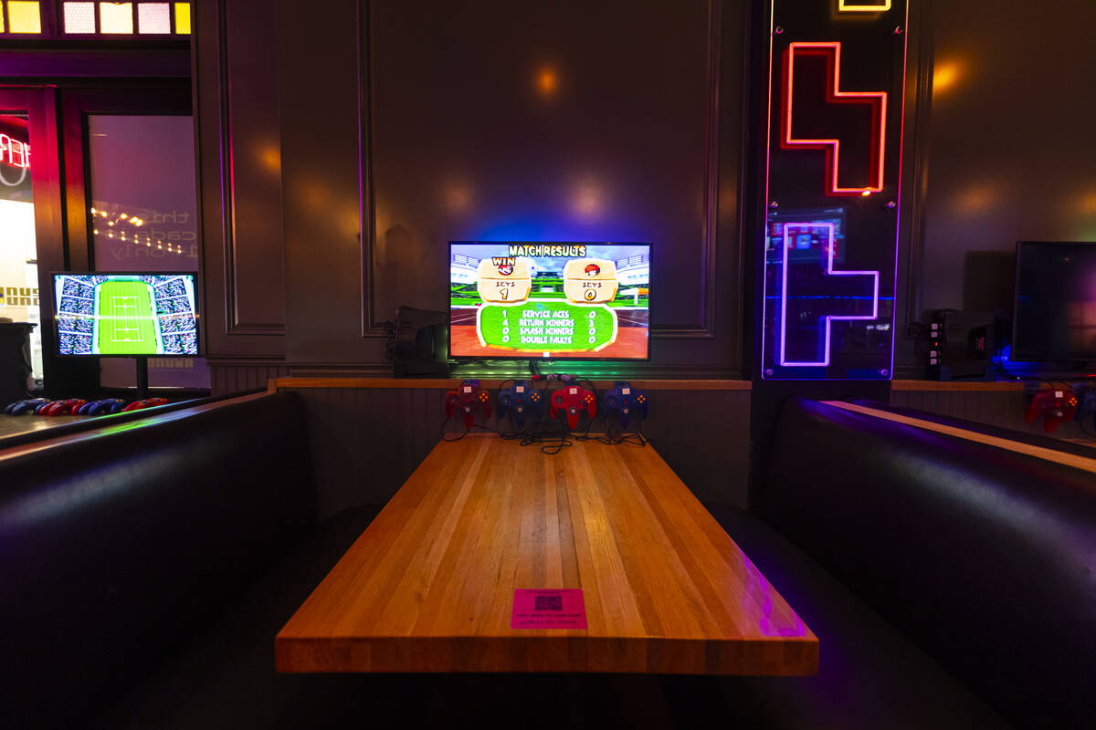 A booth with Nintendo controllers and a screen is seen at the Bonus Round arcade bar at The Dis ...