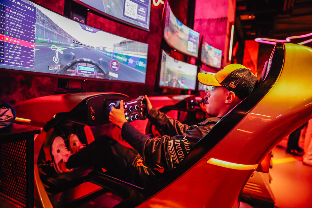 Jackson Kuhns plays a racing game inside of the Formula 1 Arcade at the Forum Shops during the ...