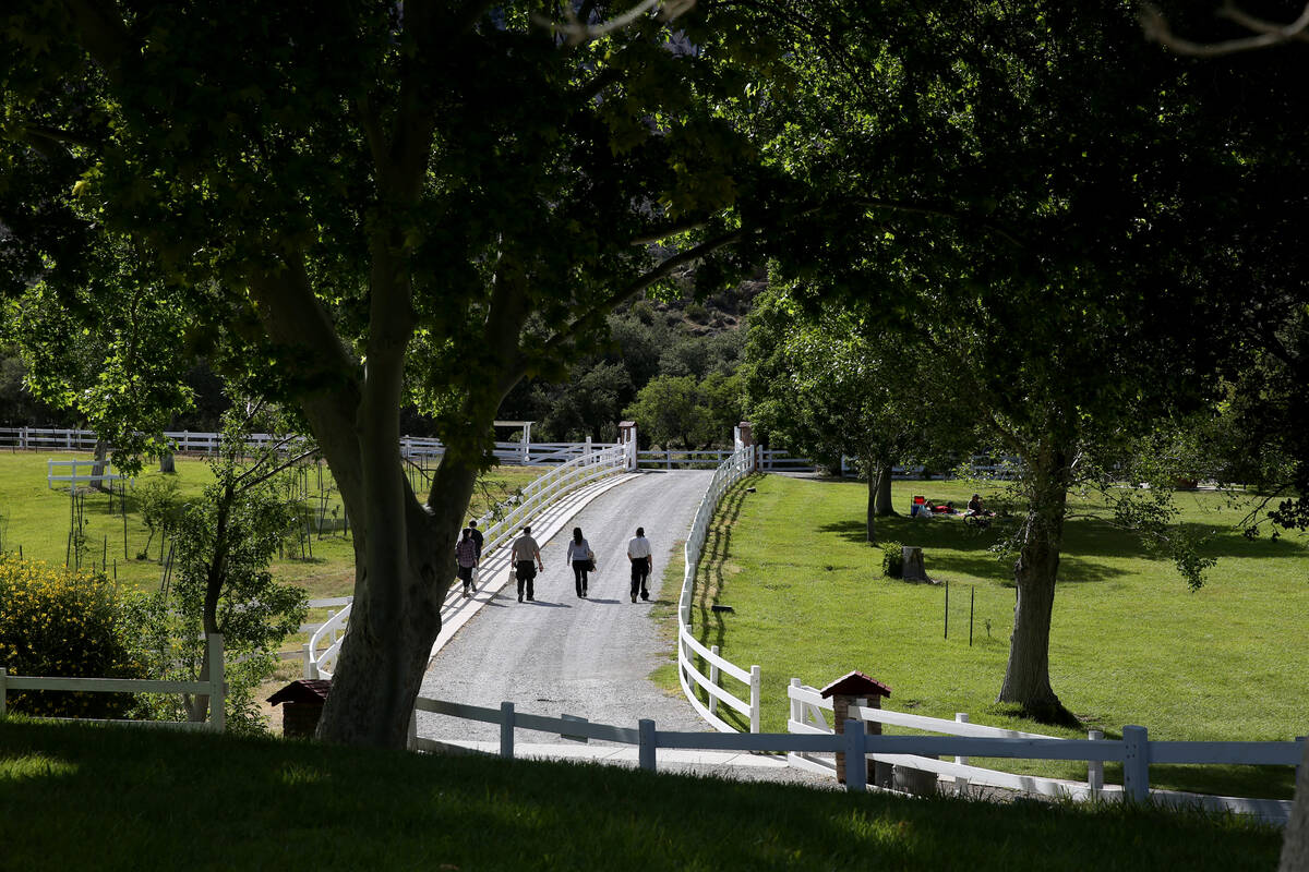 Park visitors and rangers walk at Spring Mountain Ranch State Park near Blue Diamond, Friday, M ...