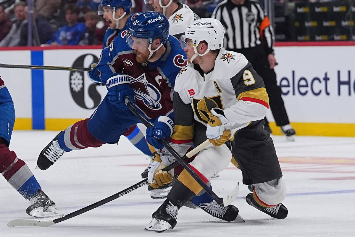 Colorado Avalanche left wing Gabriel Landeskog, left, checks Vegas Golden Knights center Jack E ...