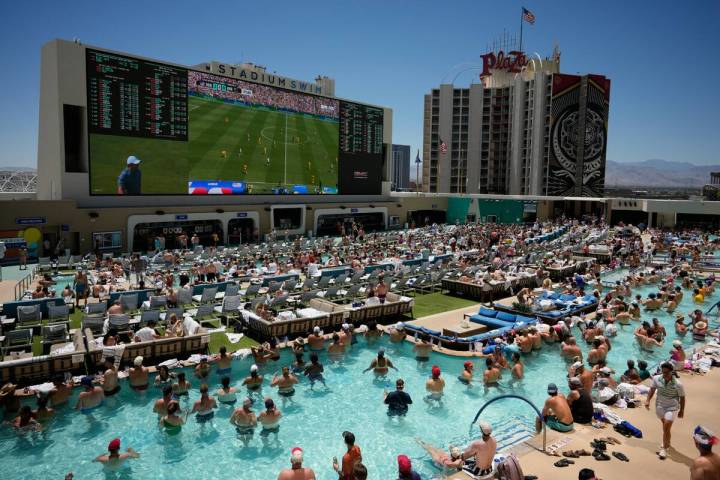 Fans watch a live broadcast of a World Cup soccer match between the U.S. and Australia from a p ...