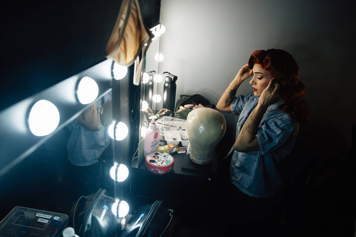 Ali Vesey gets into her costume before a showing of ClueX, a burlesque parody, at Notoriety Liv ...