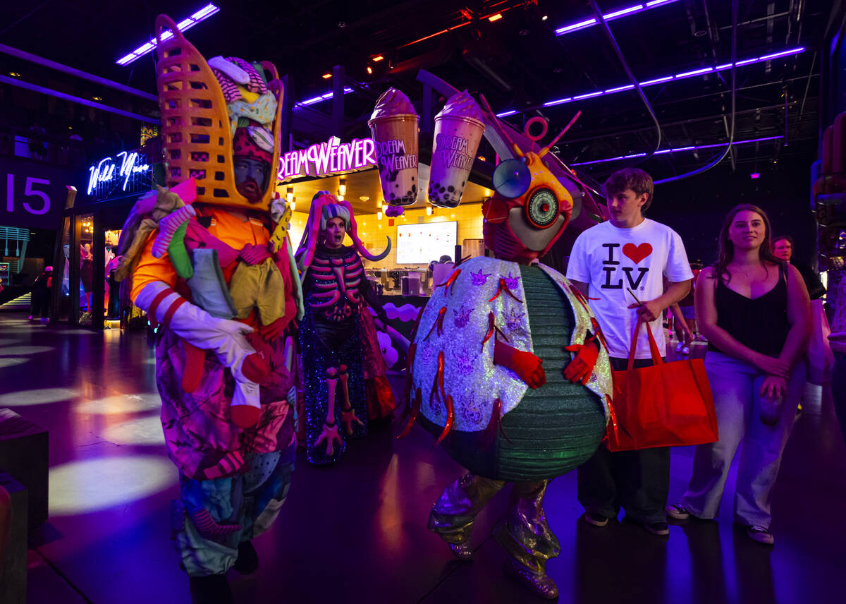 Cast members of "Phenomenomaly," an immersive experience within Omega Mart, begin the ...