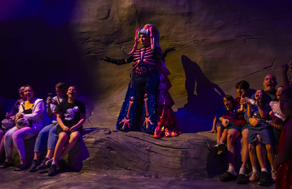 A cast member of "Phenomenomaly," an immersive experience within Omega Mart, interact ...