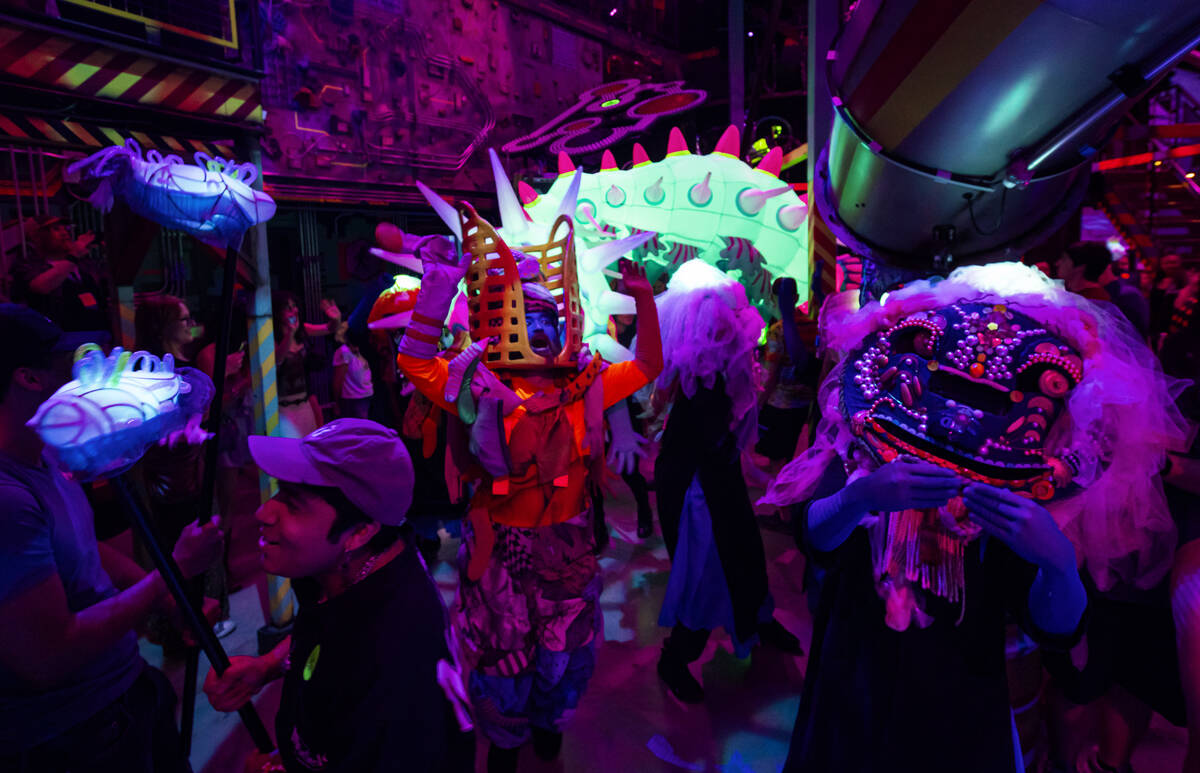Cast members of "Phenomenomaly," an immersive experience within Omega Mart, perform a ...