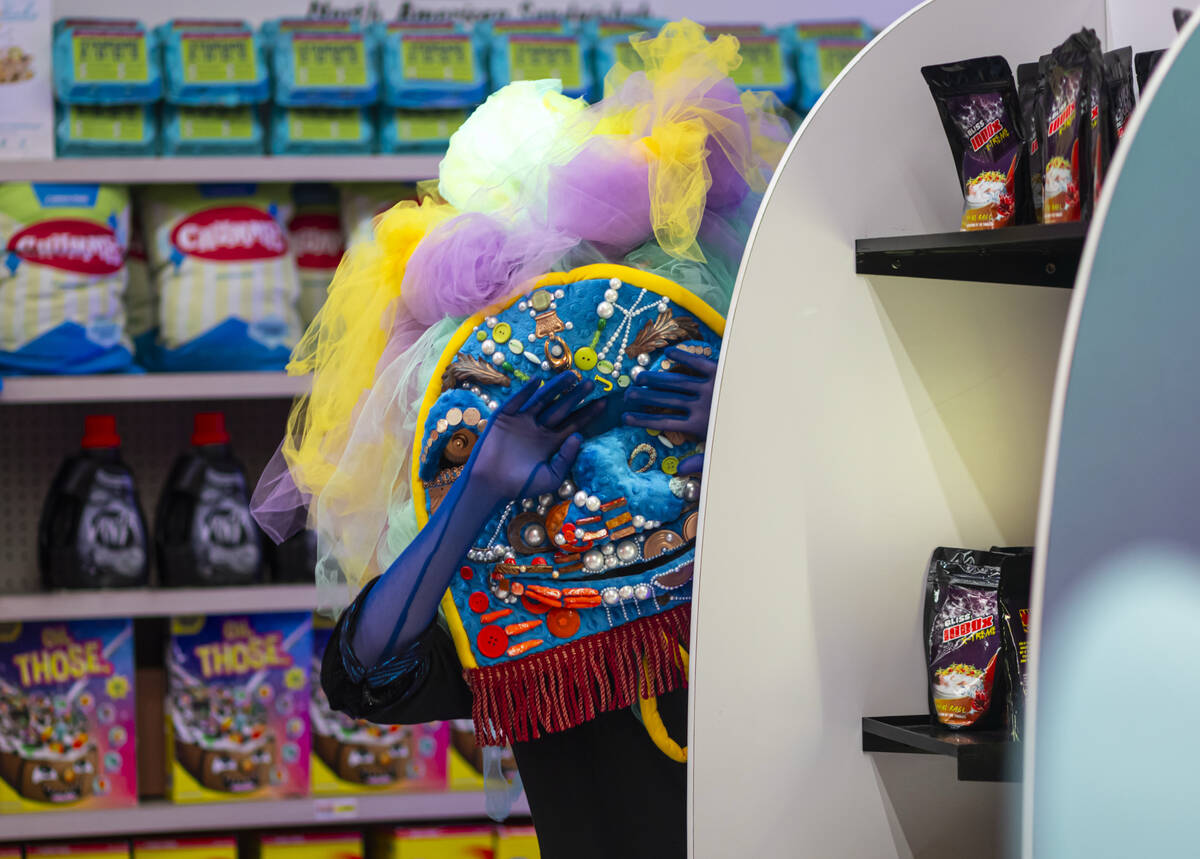 A cast member of "Phenomenomaly," an immersive experience within Omega Mart, performs ...