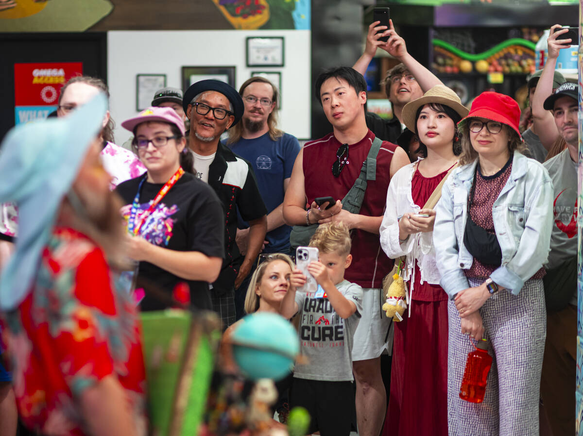 People watch as cast members of "Phenomenomaly," an immersive experience within Omega ...