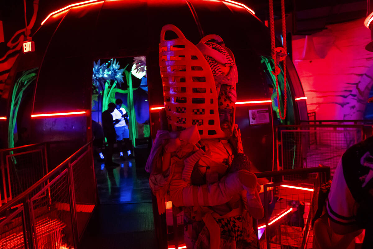 A cast member of "Phenomenomaly," an immersive experience within Omega Mart, interact ...