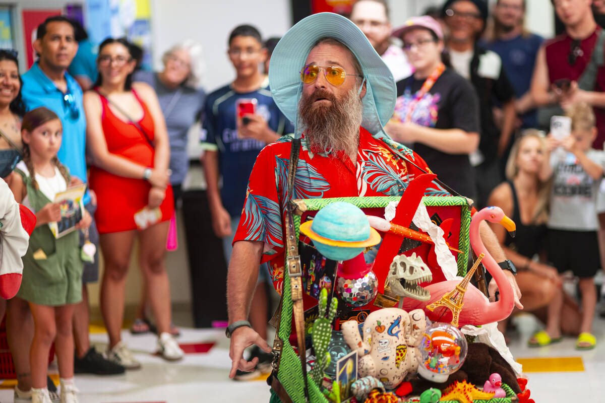 A cast member of "Phenomenomaly," an immersive experience within Omega Mart, performs ...
