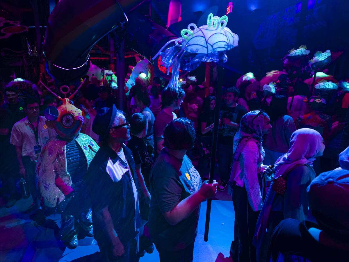 Attendees interact with cast members of "Phenomenomaly," an immersive experience with ...