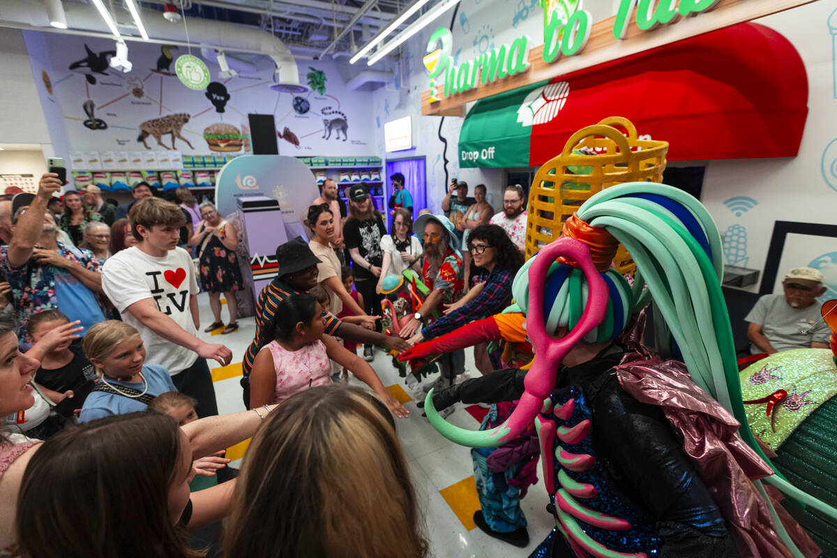 Cast members of "Phenomenomaly," an immersive experience within Omega Mart, interact ...