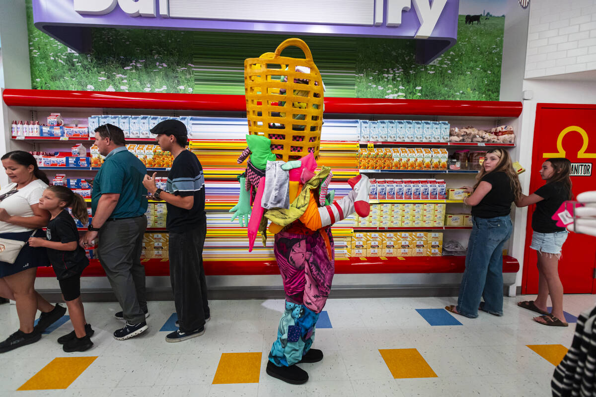 A cast member of "Phenomenomaly," an immersive experience within Omega Mart, interact ...