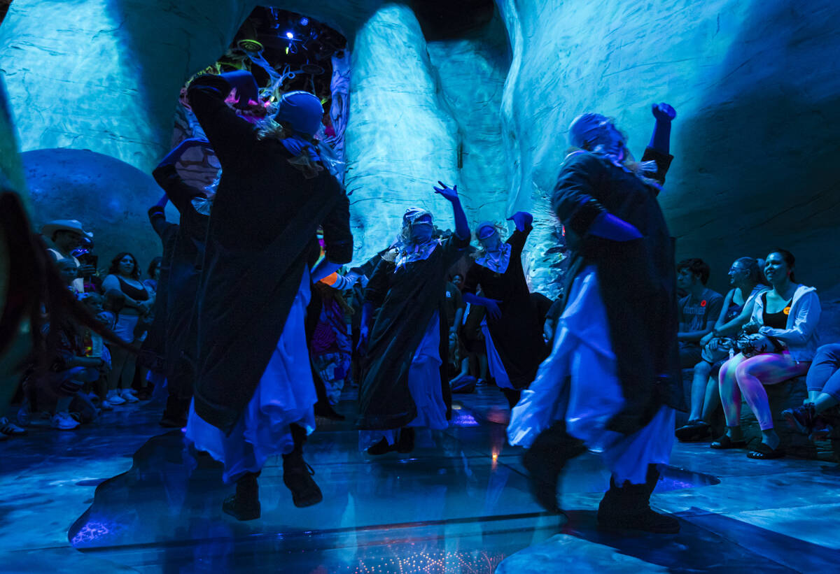 Cast members of "Phenomenomaly," an immersive experience within Omega Mart, perform a ...