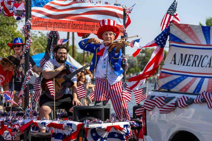 The Americana Man plays for the crowd as his float moves along the route during the 77th Annual ...