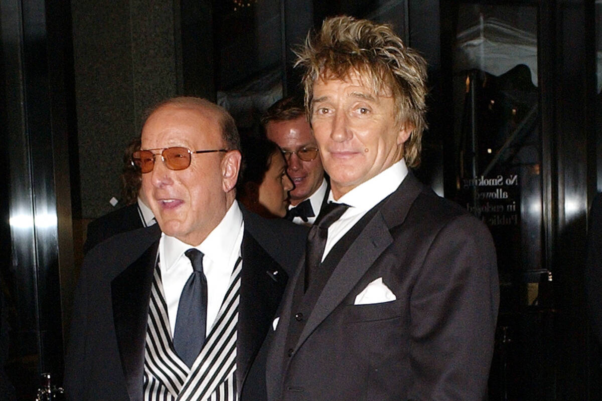 Record producer Clive Davis, left, and rock singer Rod Stewart arrive at Davis' pre-Grammys gal ...
