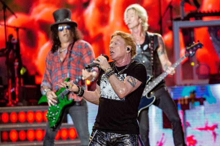 Axl Rose, center, Slash, back left and Duff McKagan, back right of Guns N' Roses perform d ...